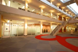interior of a modern office building or a corporate lobby, possibly featuring multiple floors and open workspaces